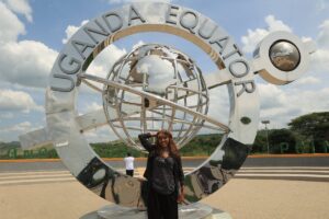 Visitors pose at the Kikorongo Equator Monument in western Uganda, marking the point where the Equator crosses the Mbarara-Kasese highway
