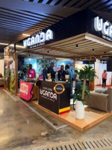 The vibrant Explore Uganda - The Pearl of Africa exhibition stand at ExpoBéton RDC 2026 features wildlife imagery, cultural displays, and networking spaces designed to promote cross-border travel and sustainable tourism investment between Uganda and the Democratic Republic of Congo
