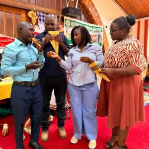 Participants examine traditional pan flutes during the cultural exhibition at the Stakeholder Policy Dialogue on Cultural Enterprises for Women from Uganda’s Indigenous Minority Groups