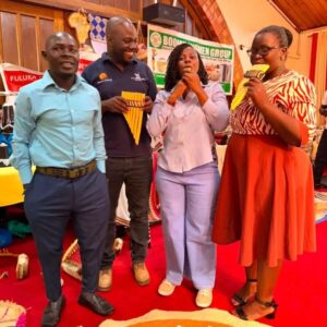 Participants try out traditional musical instruments at the cultural showcase held alongside the Stakeholder Policy Dialogue on Cultural Enterprises for Women from Uganda’s Indigenous Minority Groups