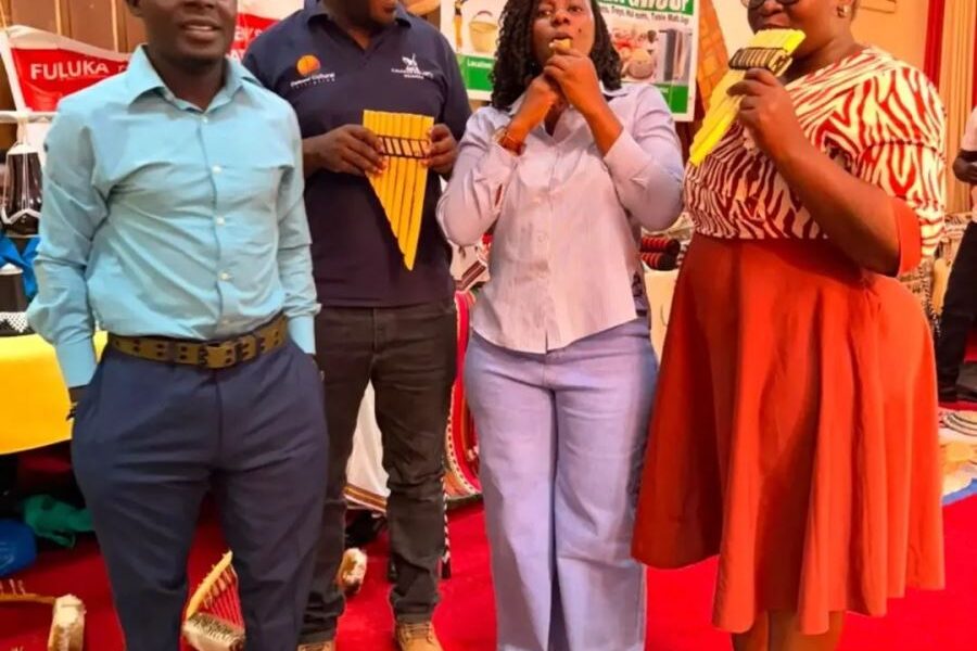 Participants try out traditional musical instruments at the cultural showcase held alongside the Stakeholder Policy Dialogue on Cultural Enterprises for Women from Uganda’s Indigenous Minority Groups