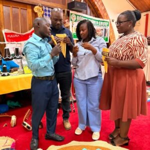 Attendees interact with traditional pan flutes during the exhibition component of the Stakeholder Policy Dialogue at Kampala Kolping Hotel